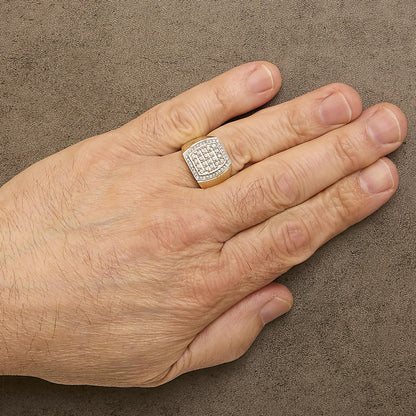 Yellow metal ring with a geometric shield-shaped top featuring two rows of round white gemstones in prong settings, shown worn on a model's hand from a top angle.