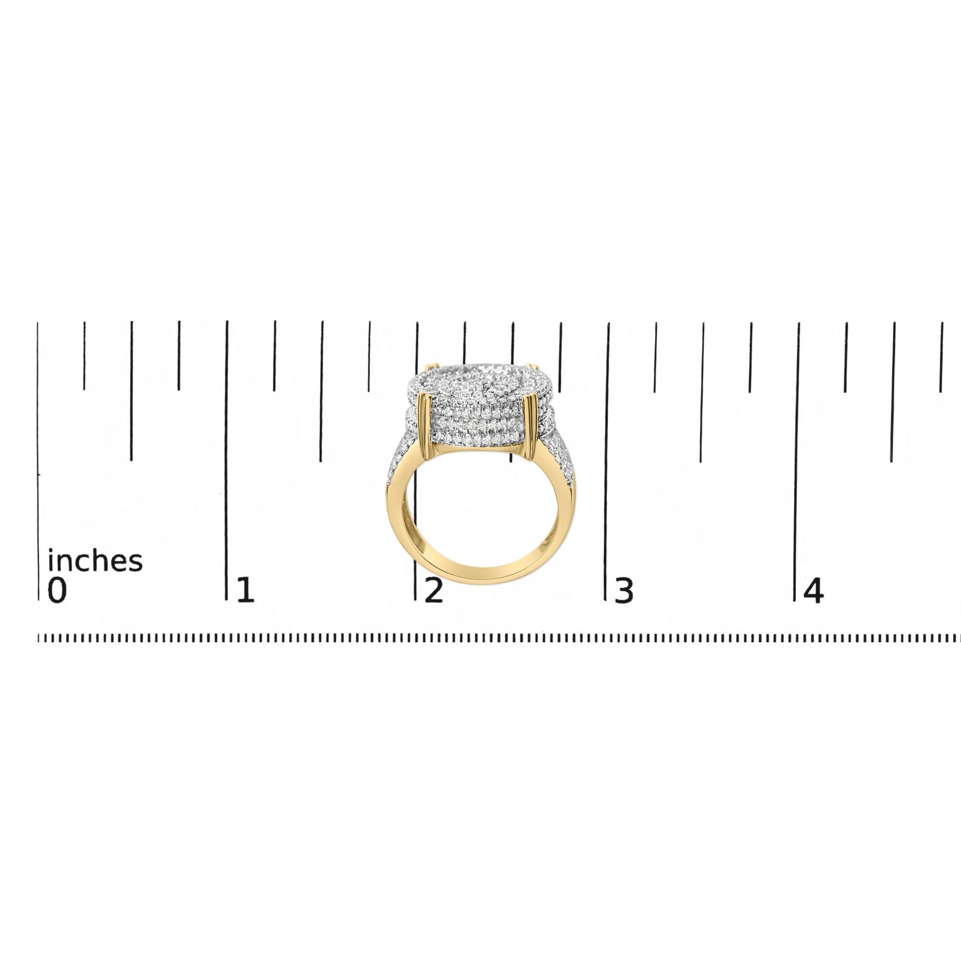 Yellow metal ring with multiple rows of white gemstones in a square cluster, shown on a ruler scale, side angle view.