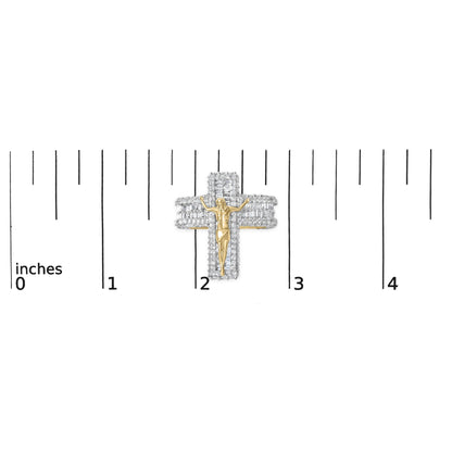 Close-up front angle of a yellow metal ring with a religious figure in the center, surrounded by multiple rows of round and baguette-shaped white gemstones, shown on a scale with inch measurements.