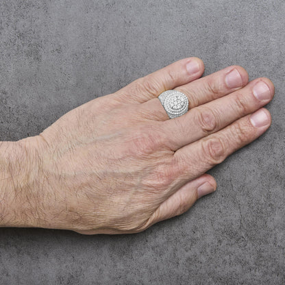 Close-up front angle of a yellow ring with multiple rows of white round gemstones in prong settings, shown worn on a model's finger.