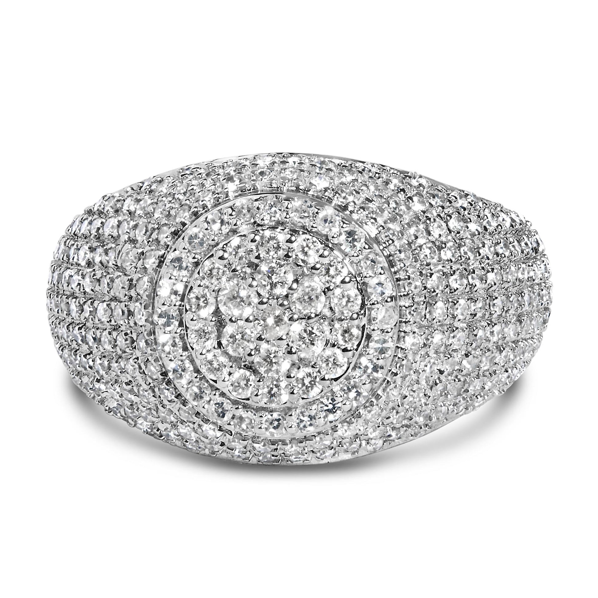 Close-up front angle of a yellow ring encrusted with multiple round white gemstones in prong settings arranged in concentric oval patterns.