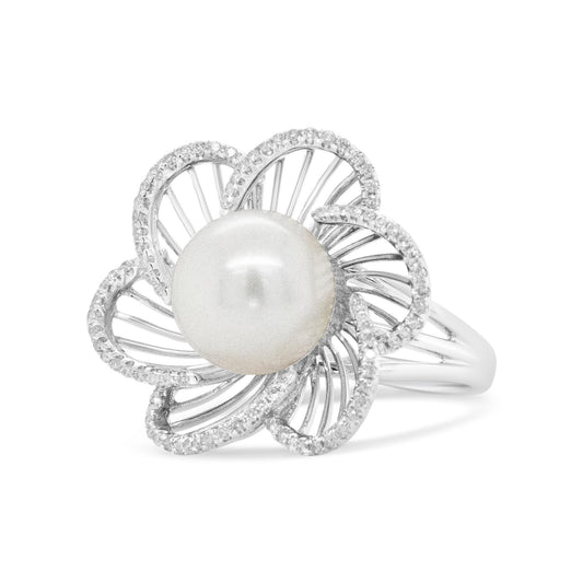White metal ring with a flower-shaped design featuring a central smooth round pearl surrounded by petals outlined with small white gemstones, shown in a front angle view.