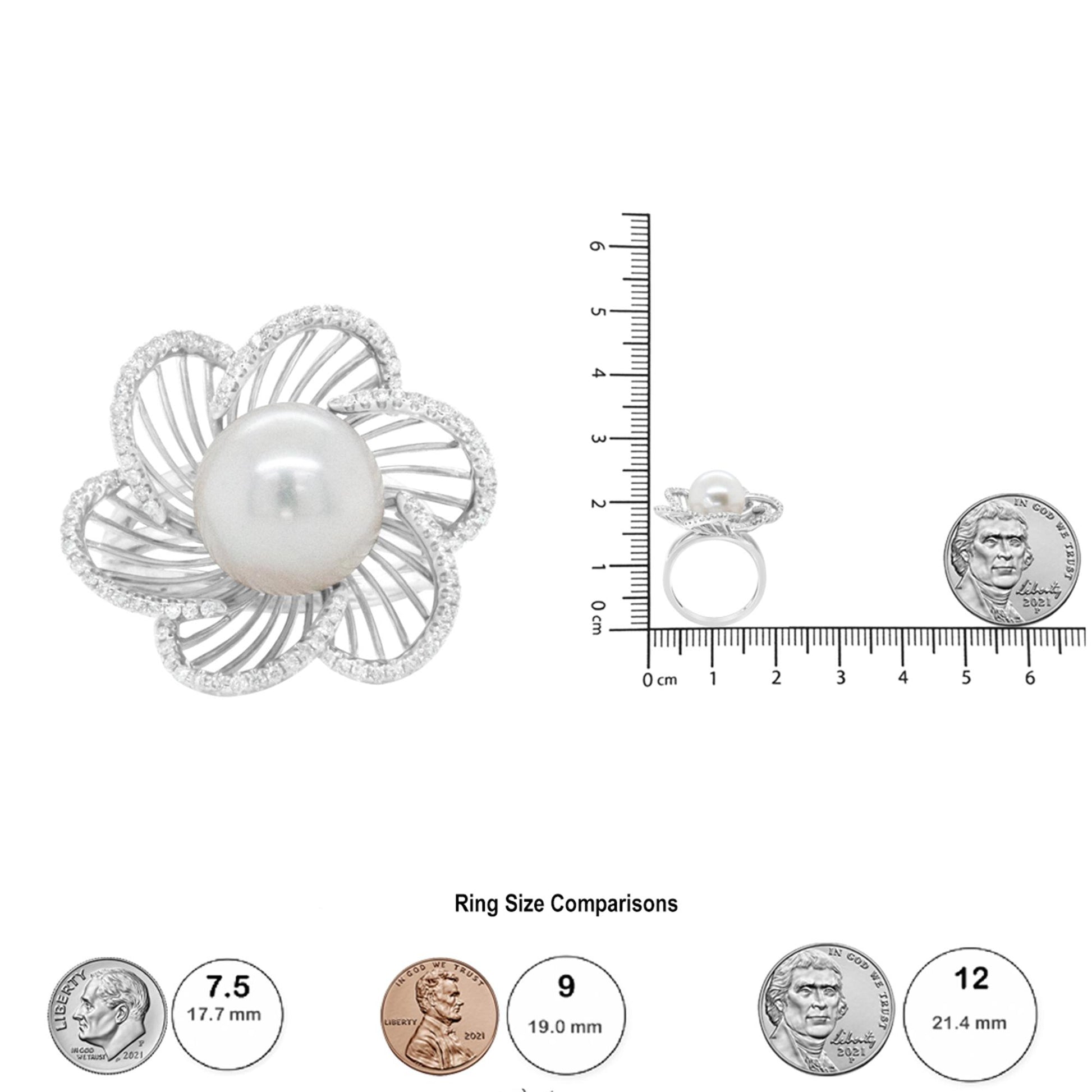 Top view of a white metal ring with a large central round white gemstone surrounded by open petal-shaped elements encrusted with small round white gemstones in pave setting, shown next to a ruler and coins for size reference.