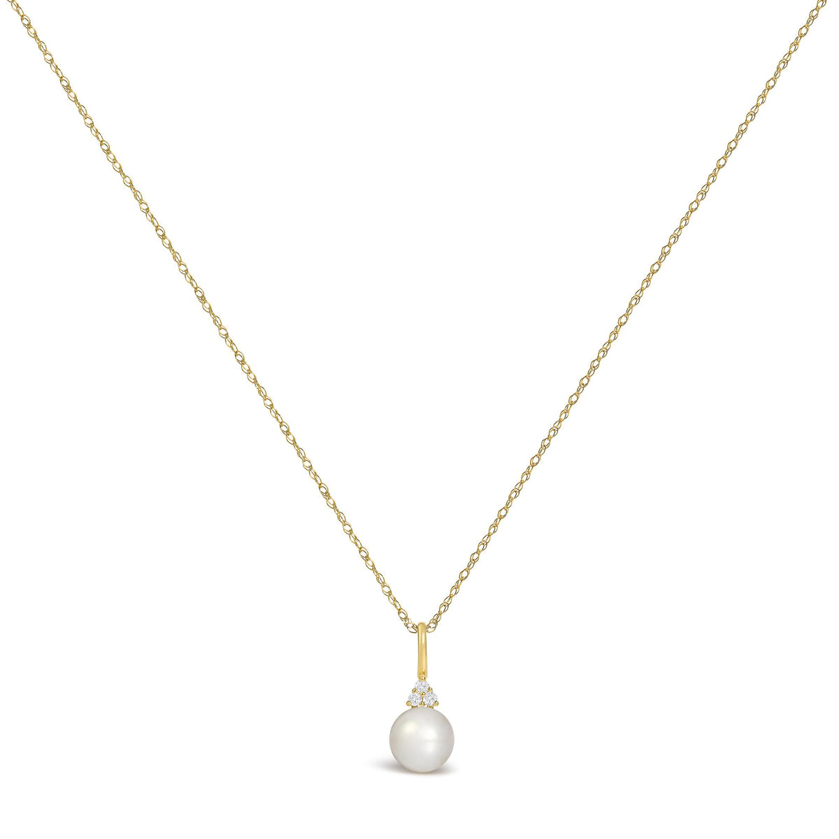 Close-up front view of a yellow metal necklace with a small pendant featuring three round white gemstones in a prong setting above a single pearl, shown on a white background.