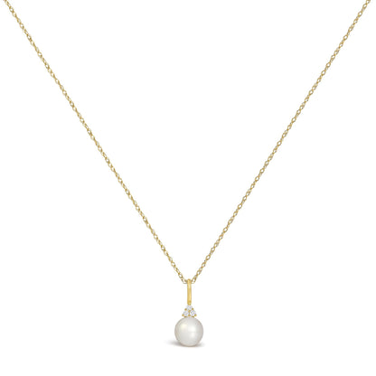 Close-up front view of a yellow metal necklace with a small pendant featuring three round white gemstones in a prong setting above a single pearl, shown on a white background.