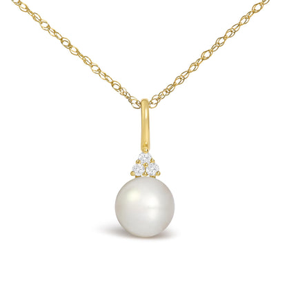 Close-up front view of a yellow necklace chain with a pendant featuring three prong-set round white gemstones above a large white pearl.