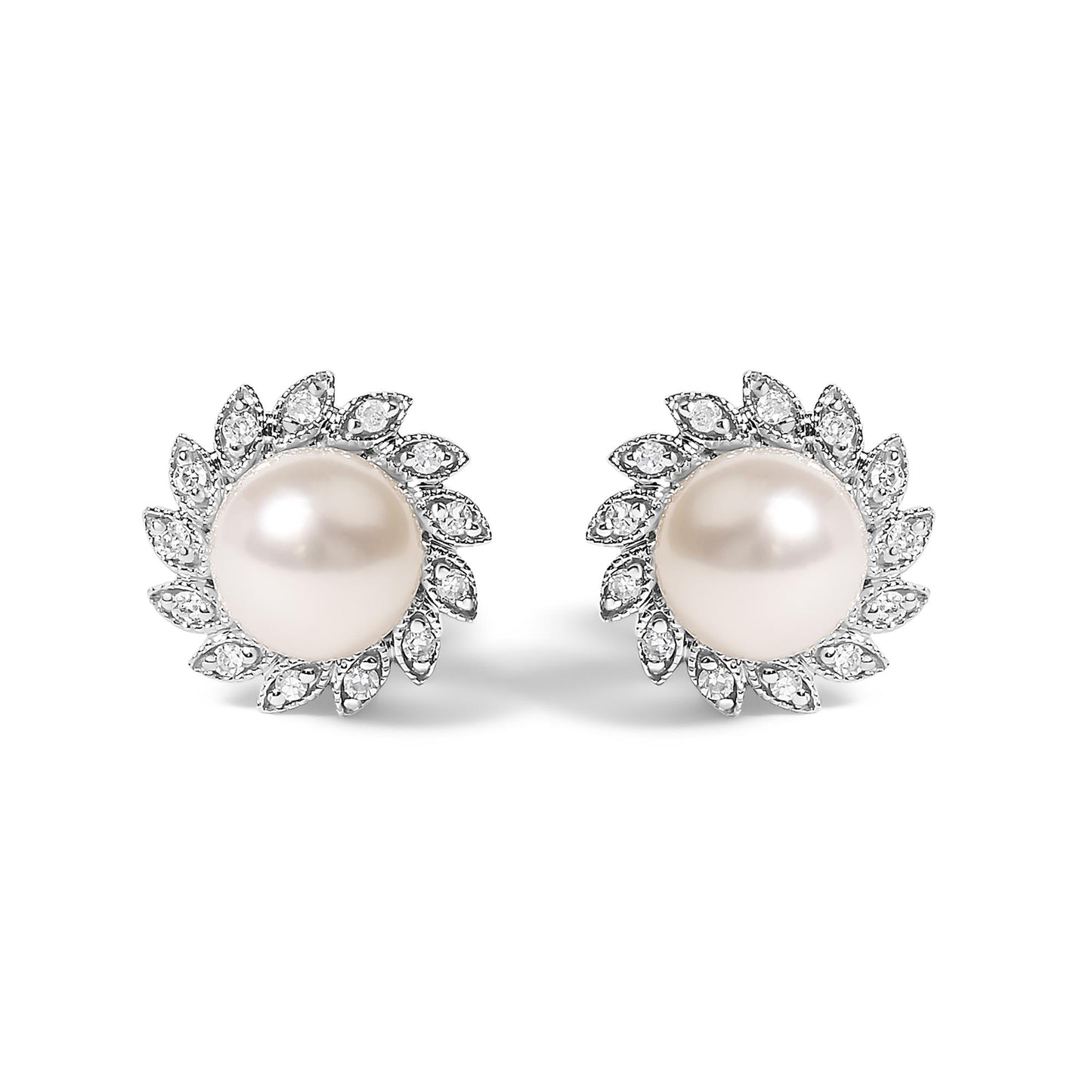 Pair of white metal stud earrings with round white centerpiece gemstones, surrounded by a halo of small white gemstones in a pave setting, shown from the front on a white background.