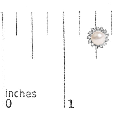 Close-up front angle of a white metal earring with a central round pearl-like gemstone surrounded by multiple marquise-shaped white gemstones in a pave setting, shown on a scale marked in inches.