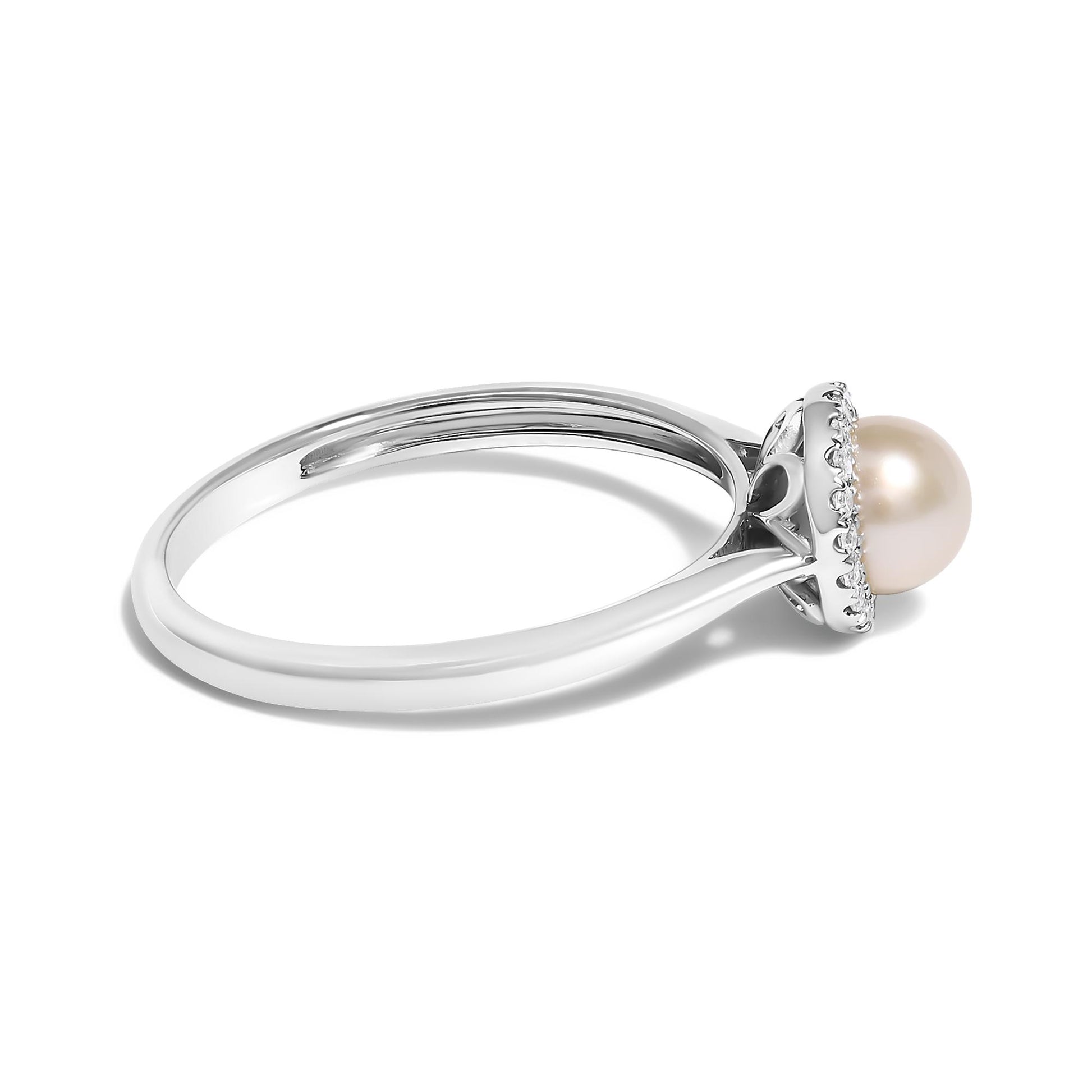 Side angle of a white metal ring featuring a central round pearl gemstone surrounded by small white gemstones in a micro-pave setting around the base.