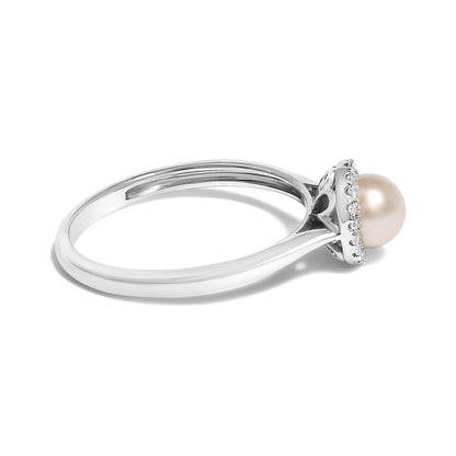 Side angle of a white metal ring featuring a central round pearl gemstone surrounded by small white gemstones in a micro-pave setting around the base.