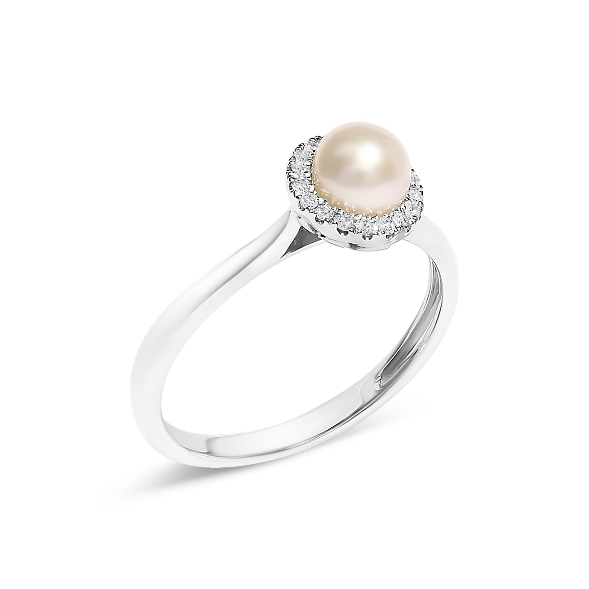 White metal ring with a central round pearl surrounded by a micro-pave setting of small white gemstones, shown at a slight angle.