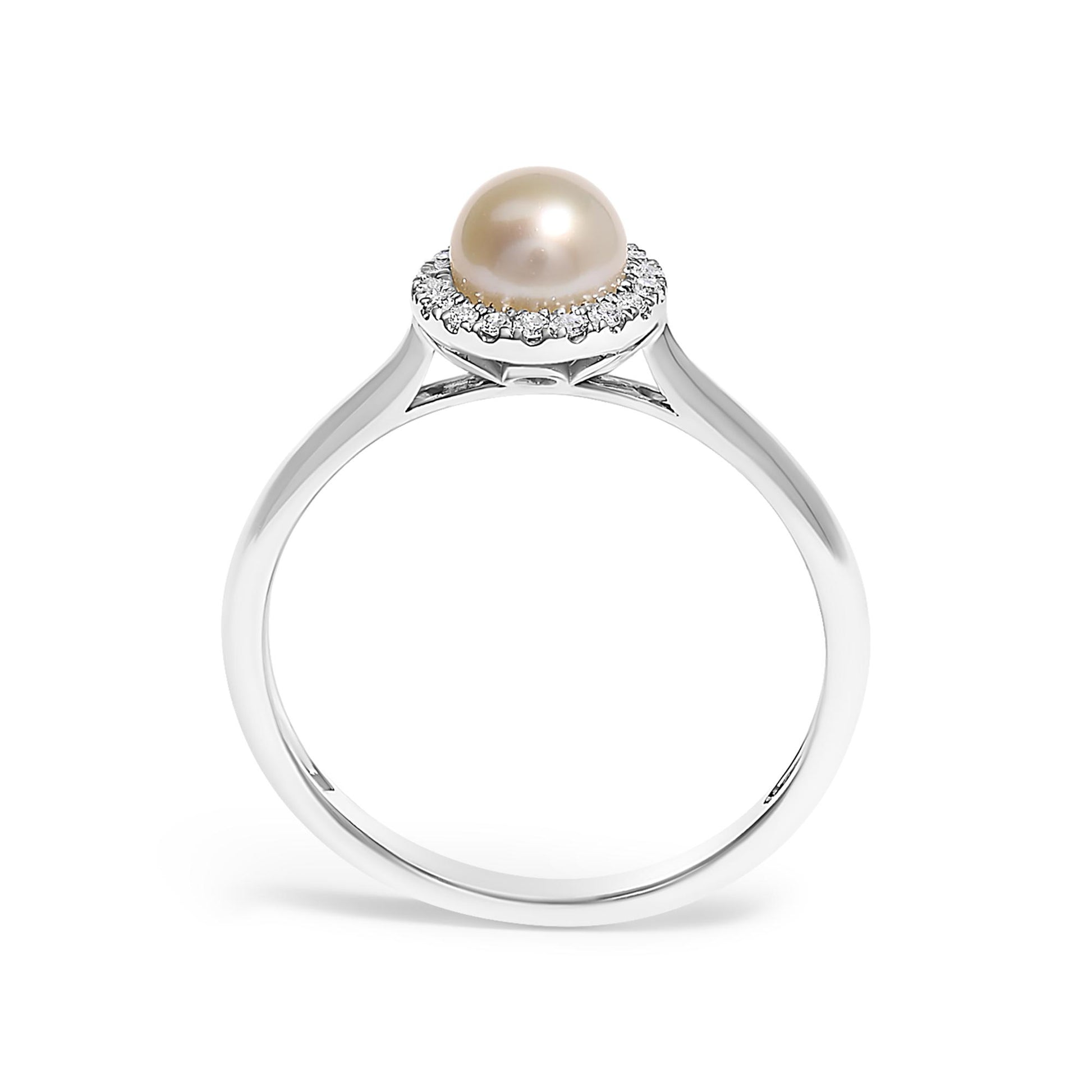 White metal ring with a central round pearl surrounded by a halo of small white gemstones in micro-pave setting, shown from the side angle on a white background.