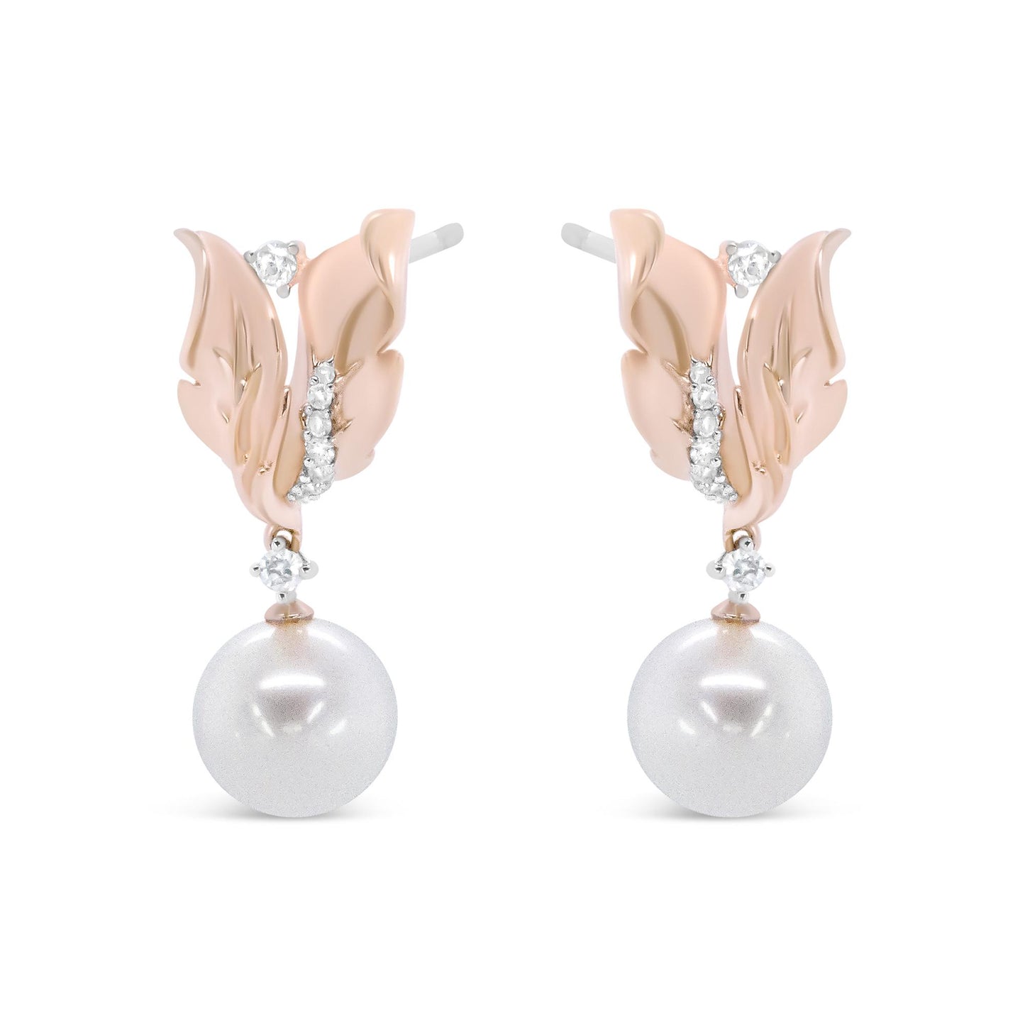 Front view of rose-colored metal earrings designed as leaves with white round gemstones in prong settings and large white round pearls hanging below.