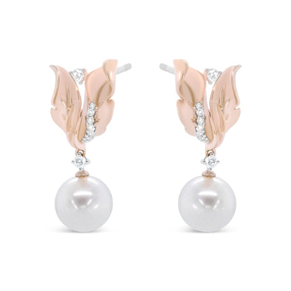 Front view of rose-colored metal earrings designed as leaves with white round gemstones in prong settings and large white round pearls hanging below.