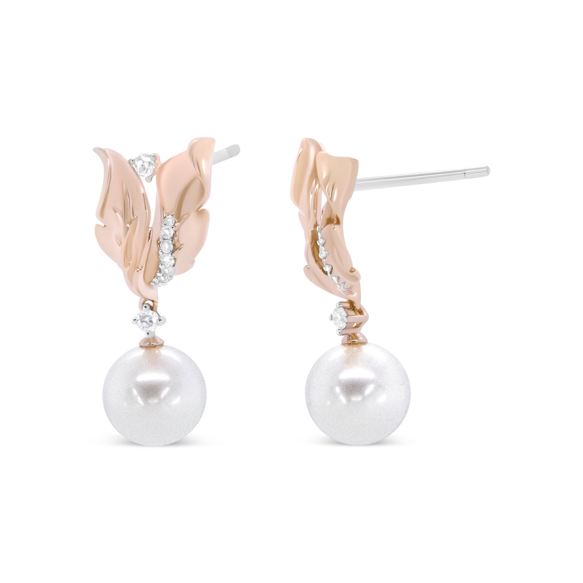 Close-up front and side view of a pair of rose metal earrings shaped like leaves with small white gemstones along the leaf edges and a white pearl-like gemstone dangling below.