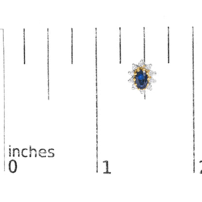 Close-up image of a yellow metal earring with an oval blue gemstone center surrounded by round white gemstones in prong settings, shown on a scale.