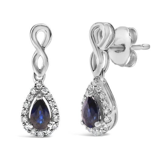 Pair of white metal earrings shown from front and side angles, featuring an infinity loop design with a teardrop-shaped blue gemstone surrounded by small white gemstones in a pave setting.