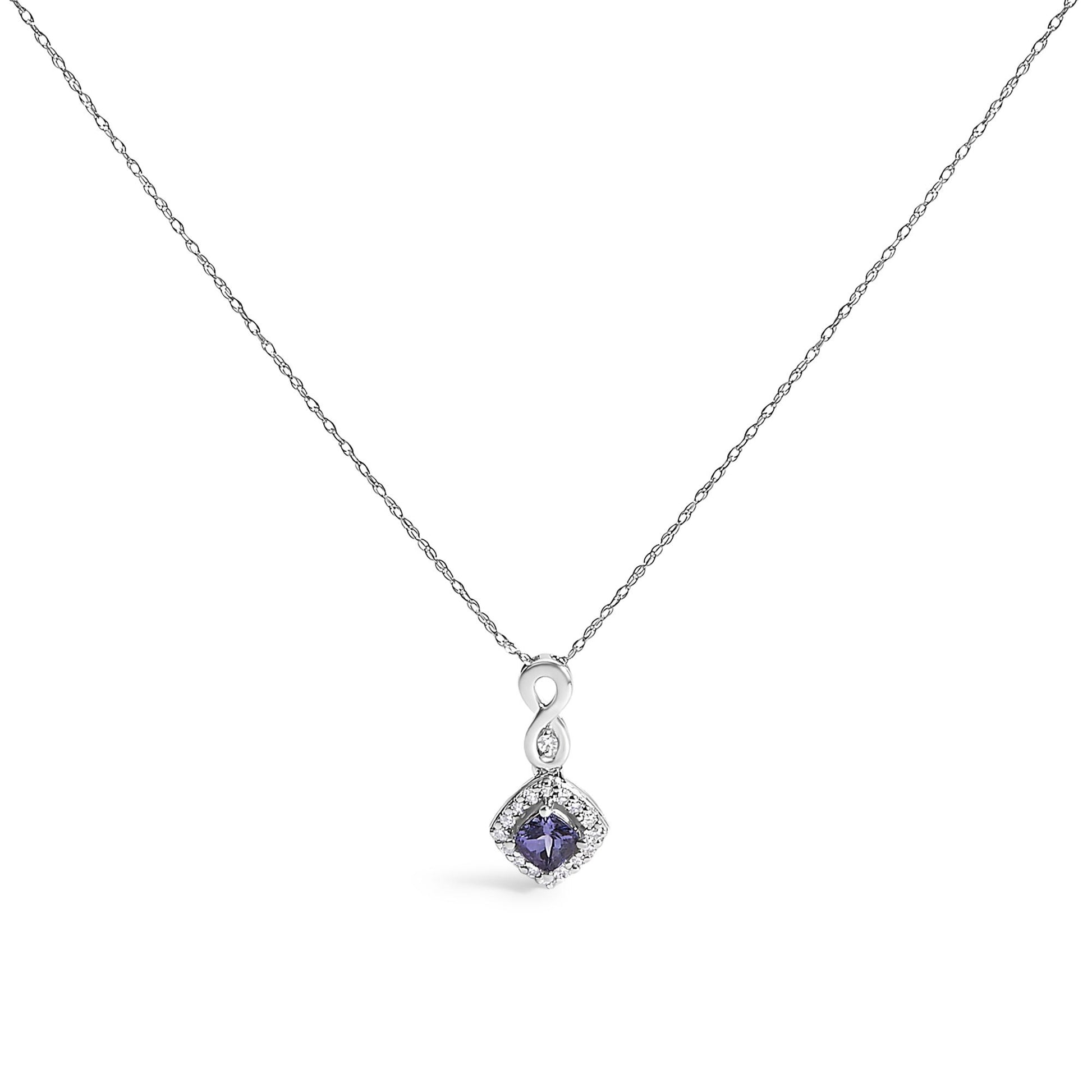 White metal necklace with a pendant featuring an infinity shape above a cushion-shaped blue gemstone surrounded by small round white gemstones, shown from the front.
