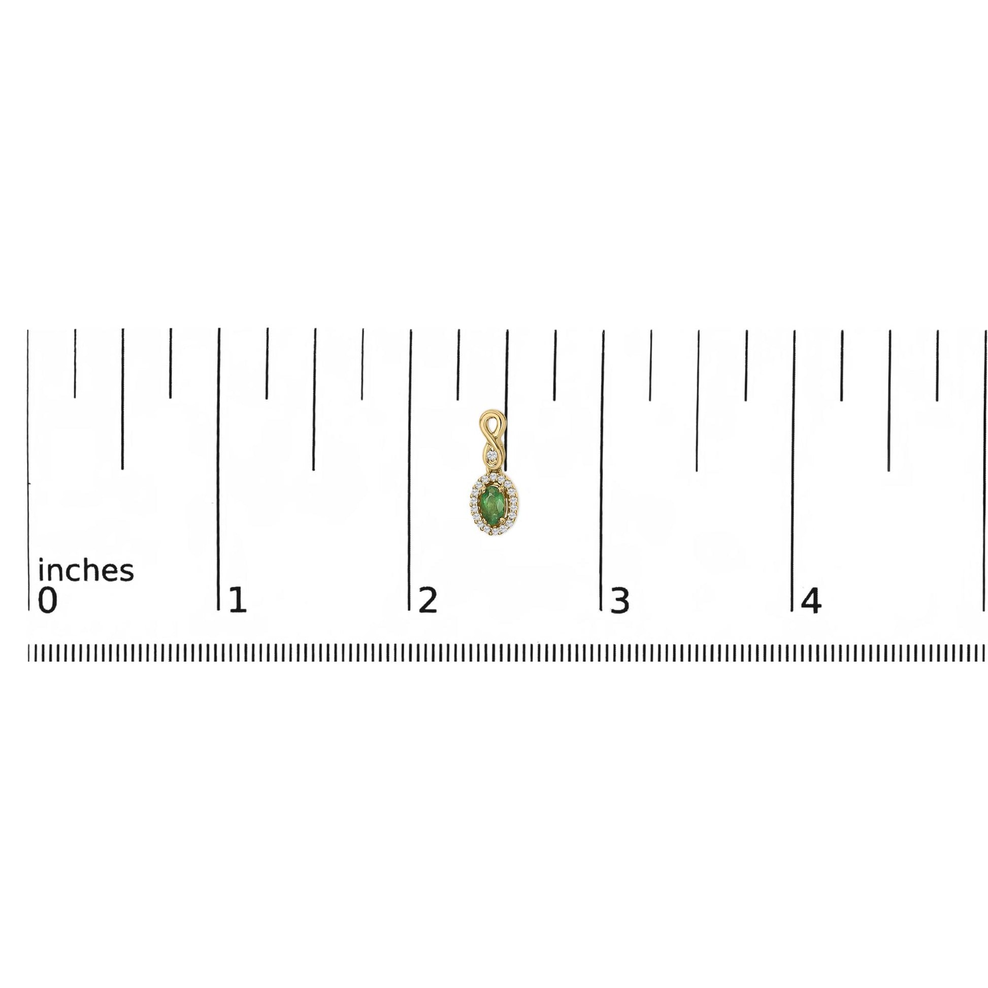 Yellow metal earring with an oval green gemstone surrounded by small white gemstones in a pave setting, shown on a scale from above.