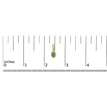 Yellow metal earring with an oval green gemstone surrounded by small white gemstones in a pave setting, shown on a scale from above.