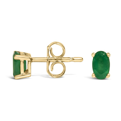 Pair of yellow metal stud earrings with oval green gemstones in prong settings, shown from side and front angles.