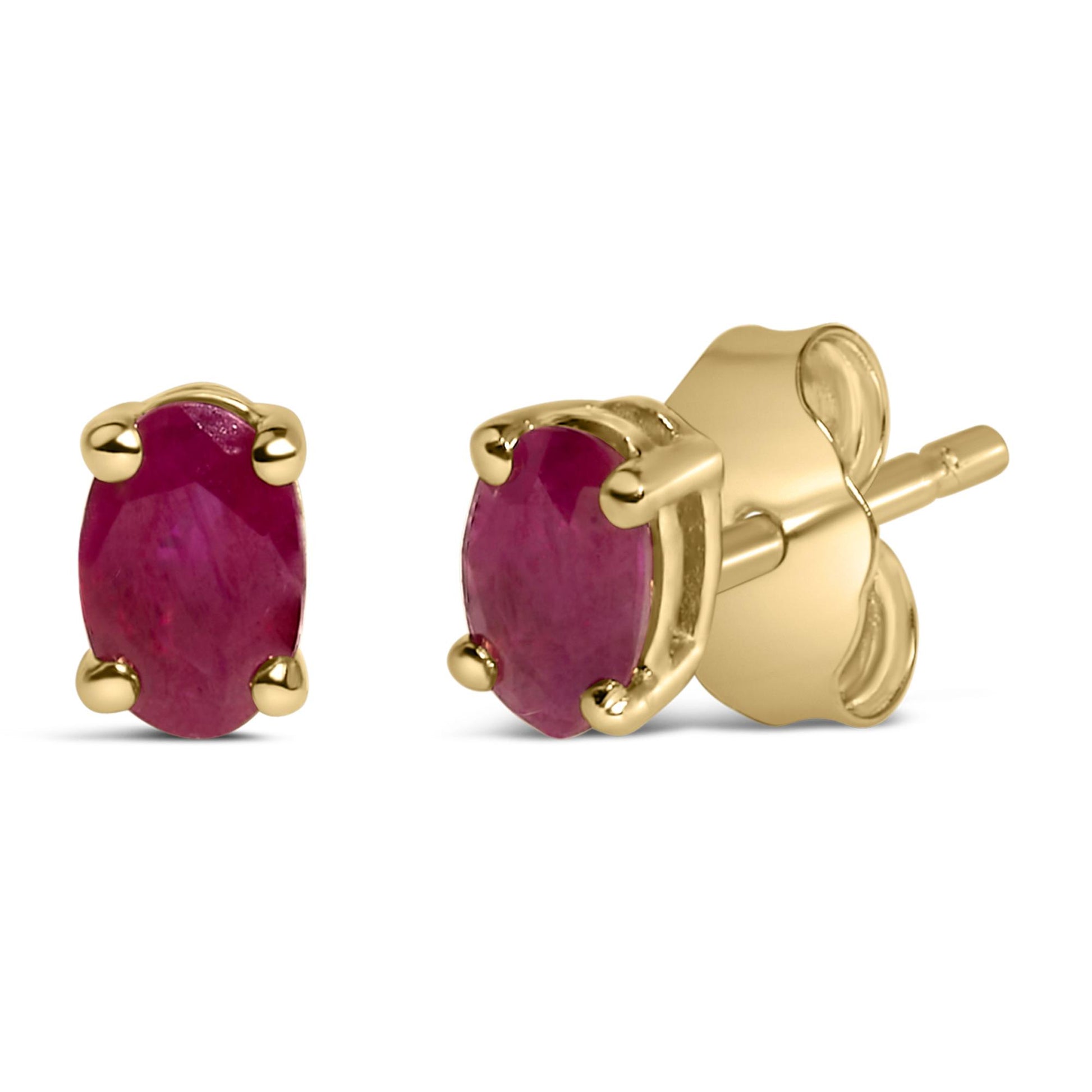 Two yellow metal stud earrings with oval red gemstones in prong settings, shown from front and side angles on a white background.