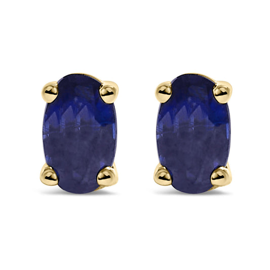 Front view of yellow metal stud earrings with oval-shaped blue gemstones in prong settings.