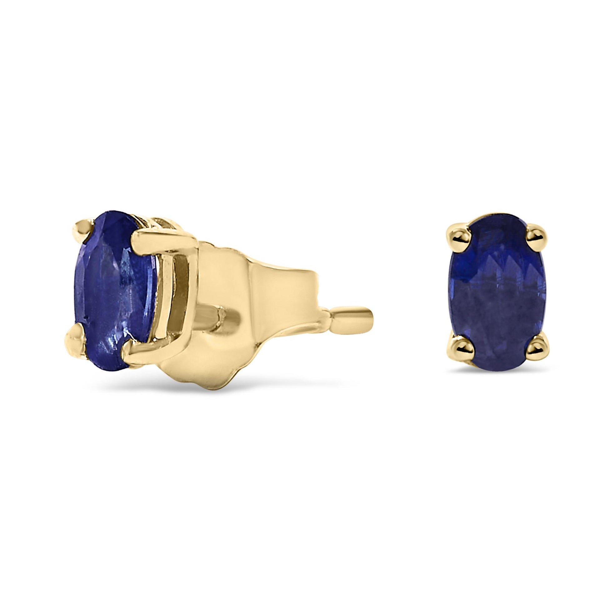 Pair of yellow metal stud earrings with oval blue gemstones in prong settings, shown from front and side angles on a white background.