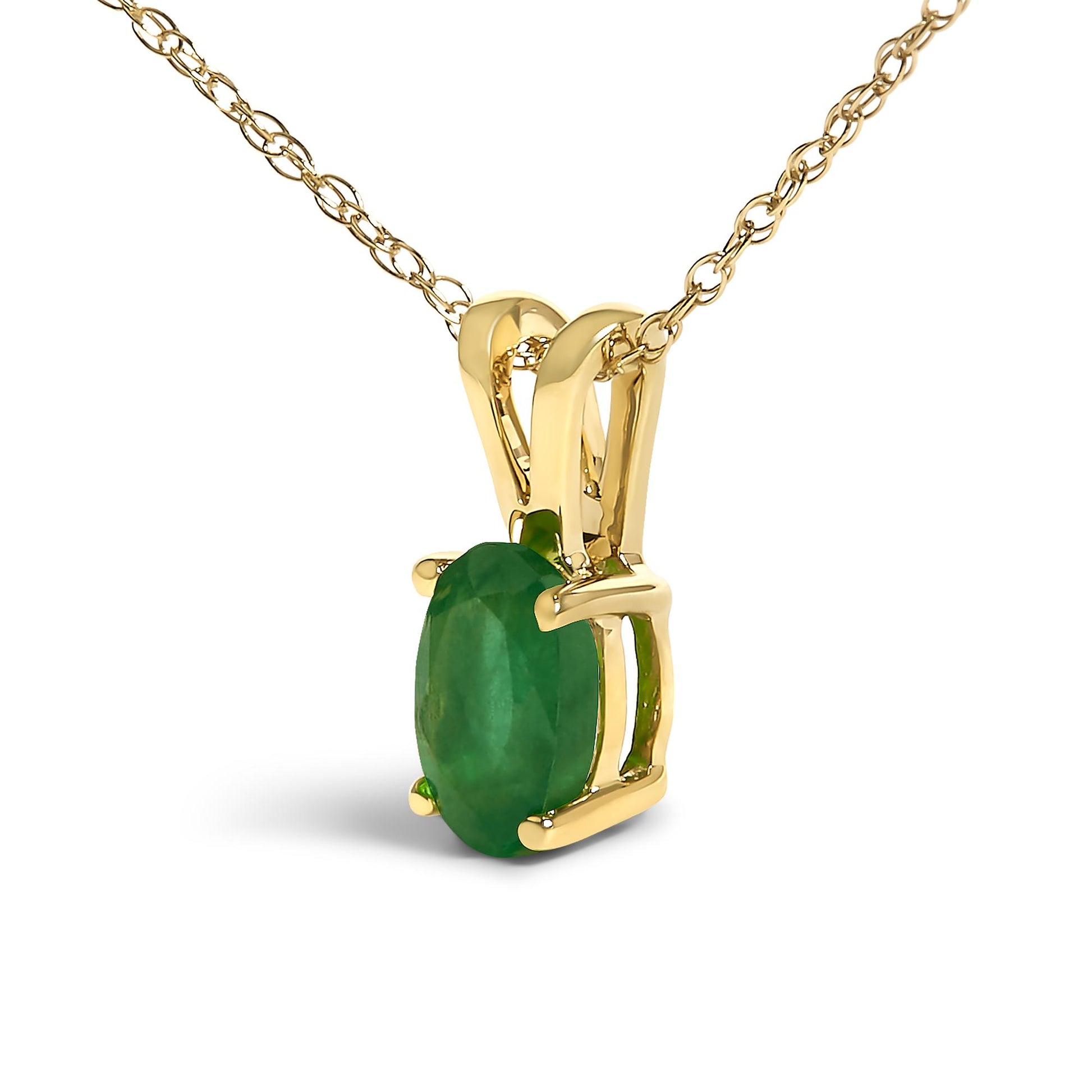 Close-up front angled view of a yellow metal necklace featuring a single oval green gemstone in a four-prong setting.