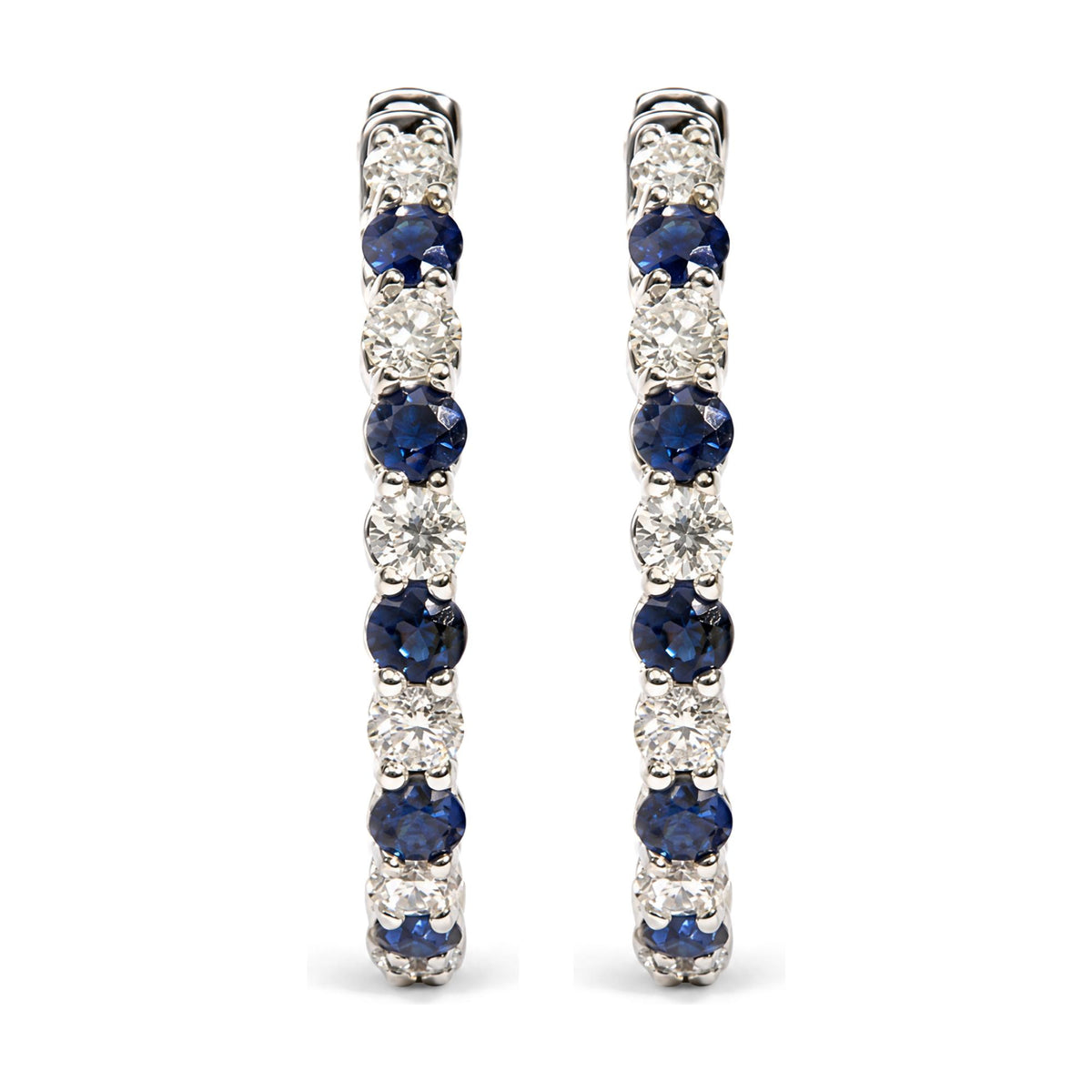 Pair of white metal hoop earrings shown from front, featuring alternating round white and blue gemstones in prong settings.