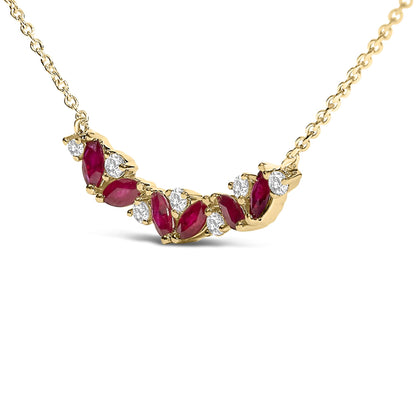Yellow metal necklace with alternating marquise shaped red gemstones and round white gemstones in prong settings, shown in a close-up front angle.