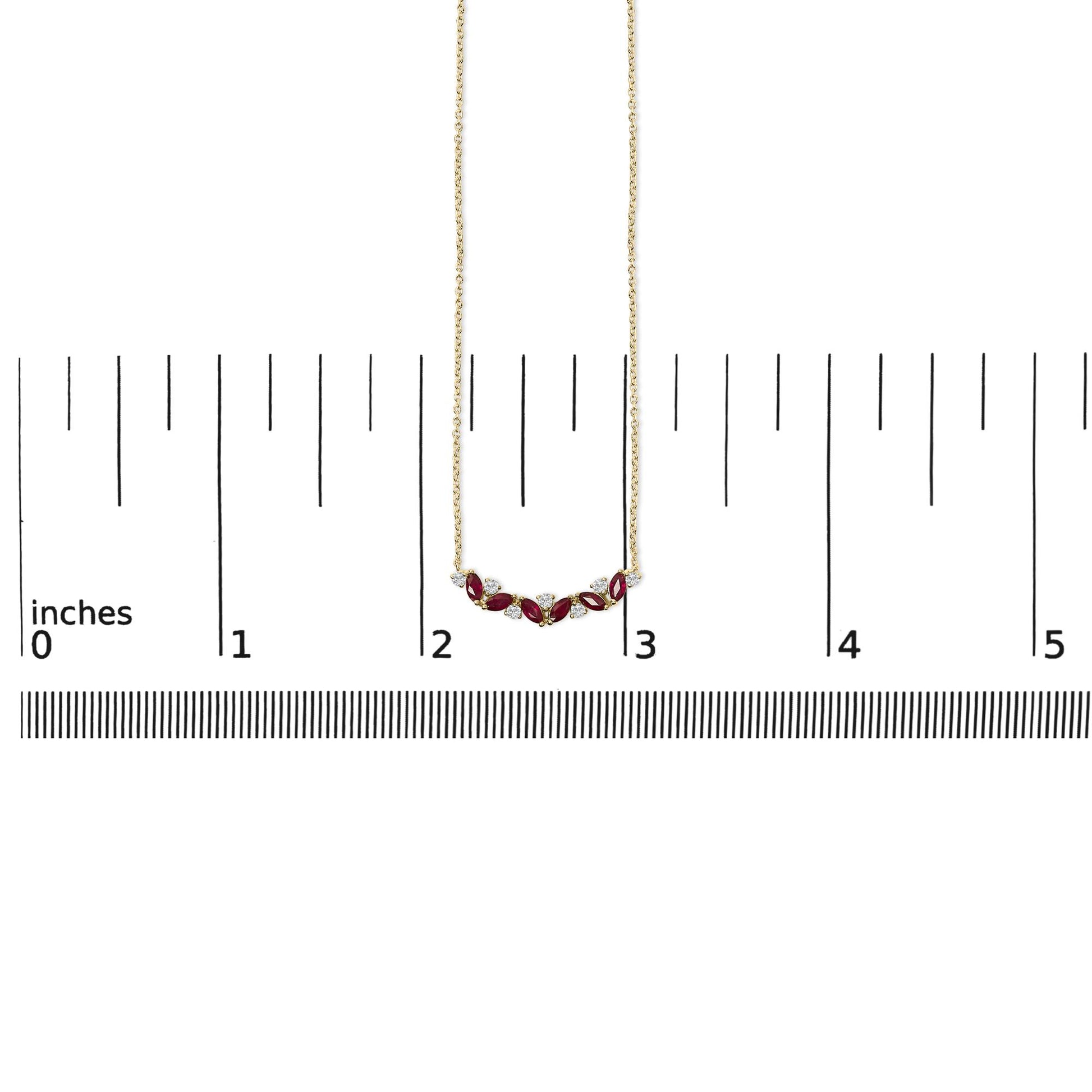 Yellow metal necklace with alternating marquise-shaped red gemstones and round white gemstones in prong settings, shown on a measuring scale, front view.