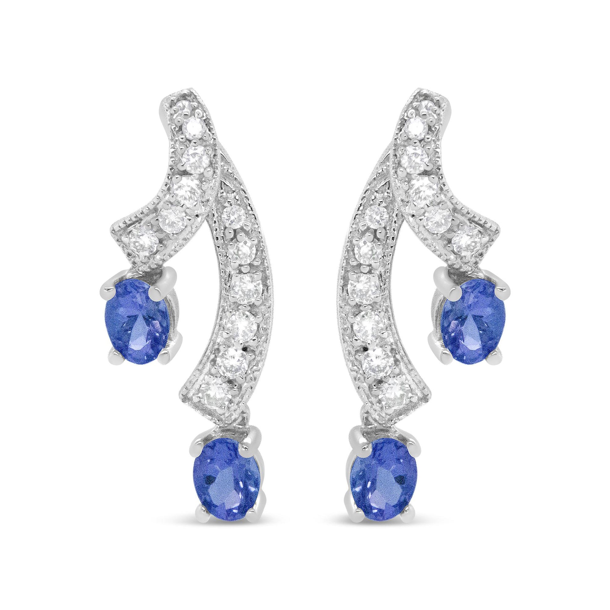 Pair of white metal earrings with curved design, prong-set with round white gemstones along the curves and blue oval gemstones at the ends, shown in a front-facing view.