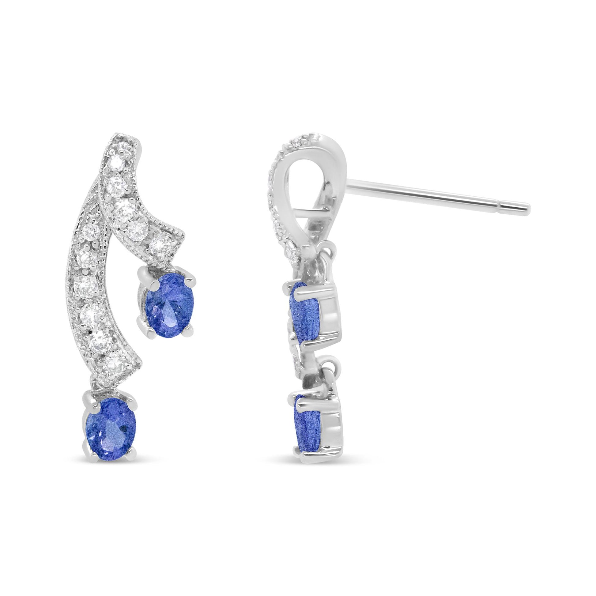 Close-up view of a pair of white metal earrings with curved design, featuring round white gemstones set in prongs along the curve and two oval blue gemstones set in prongs at the ends, shown from front and side angles on a white background.
