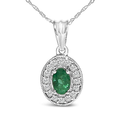 Close-up front view of a white metal necklace featuring an oval green gemstone surrounded by a halo of round white gemstones in prong settings.