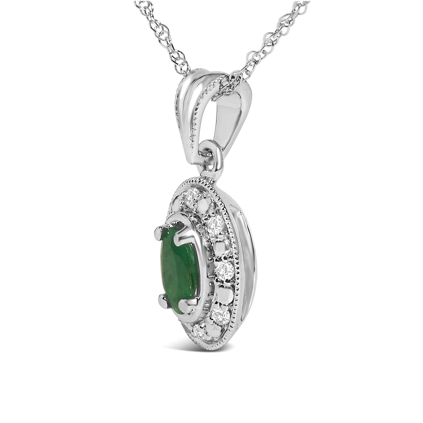 Close-up side angle of a white necklace pendant featuring an oval green gemstone in a prong setting, surrounded by multiple small round white gemstones in pave setting.