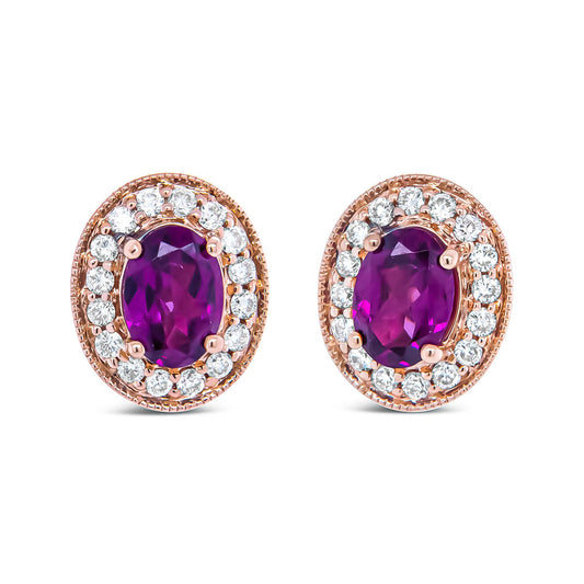 Front-facing pair of rose metal oval earrings with central red and purple oval gemstones surrounded by a halo of round white gemstones in prong settings.