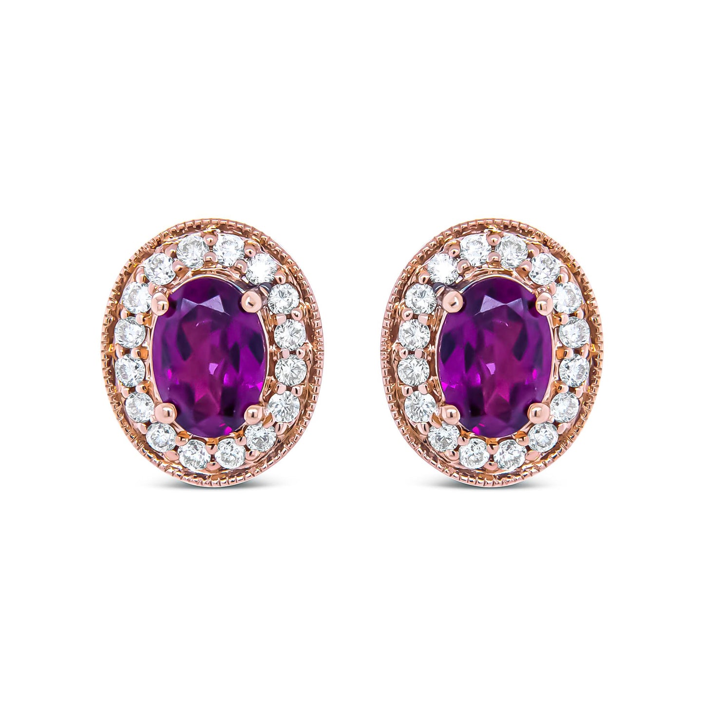 Close-up front view of a pair of rose metal oval earrings featuring a large oval red gemstone surrounded by a halo of round white gemstones in prong settings.