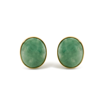 Pair of oval green gemstone bezel-set yellow metal earrings shown in a front close-up view.