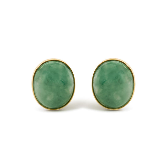 Pair of oval green gemstone bezel-set yellow metal earrings shown in a front close-up view.