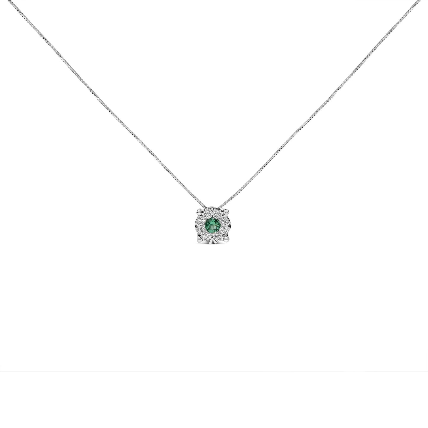 Front-facing shot of a white metal necklace with a pendant featuring a round green gemstone in a prong setting, surrounded by eight round white gemstones in a pave setting.