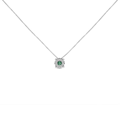 Front-facing shot of a white metal necklace with a pendant featuring a round green gemstone in a prong setting, surrounded by eight round white gemstones in a pave setting.