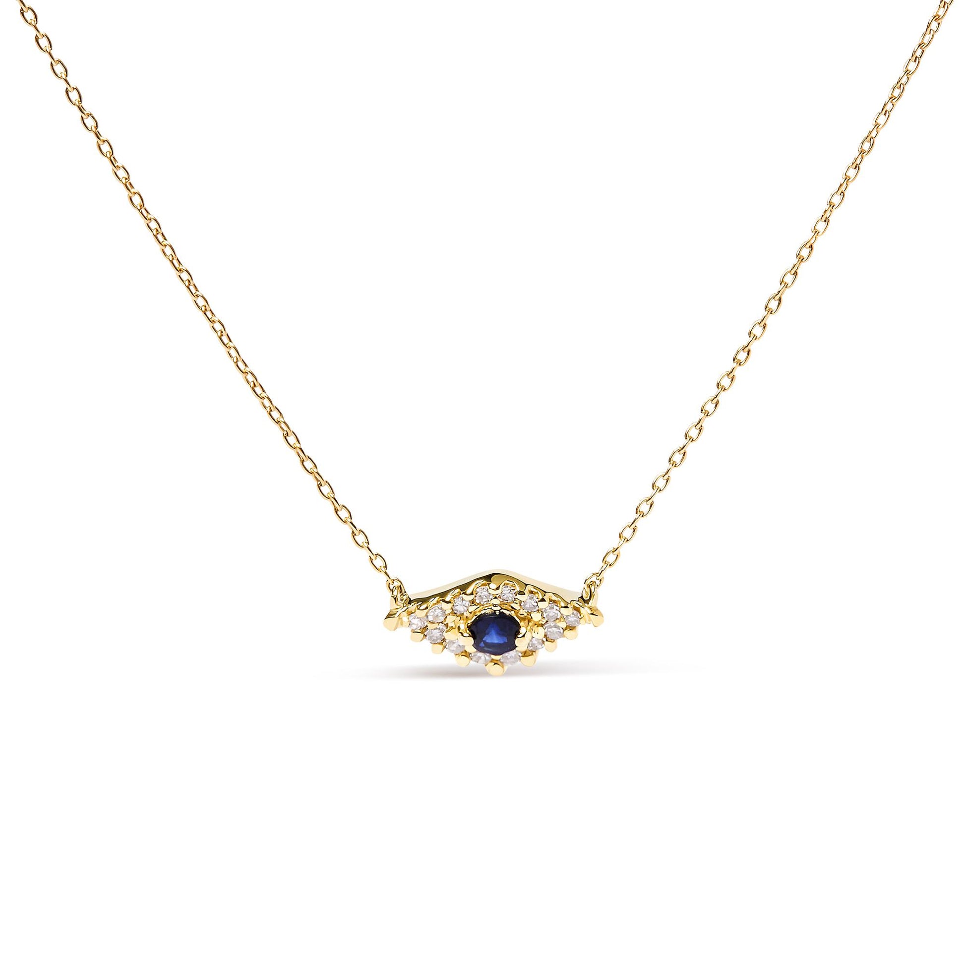 Front view of a yellow metal necklace with a central round blue gemstone surrounded by small round white gemstones in a pave setting.