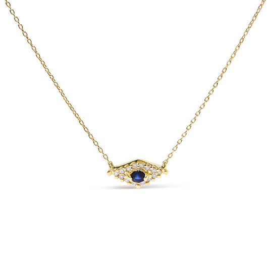 Front view of a yellow metal necklace with a central round blue gemstone surrounded by small round white gemstones in a pave setting.