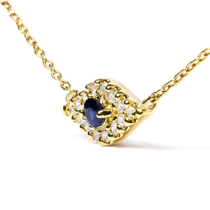 Yellow necklace with a central blue gemstone surrounded by pave-set white gemstones, shown from a slight side angle.