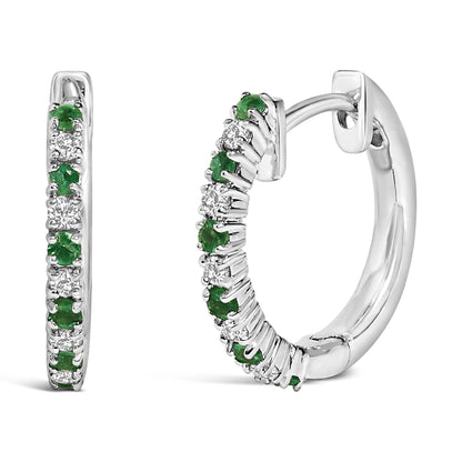 Pair of white metal hoop earrings with alternating round white and green gemstones in prong settings, shown from front and side angles on a white background.