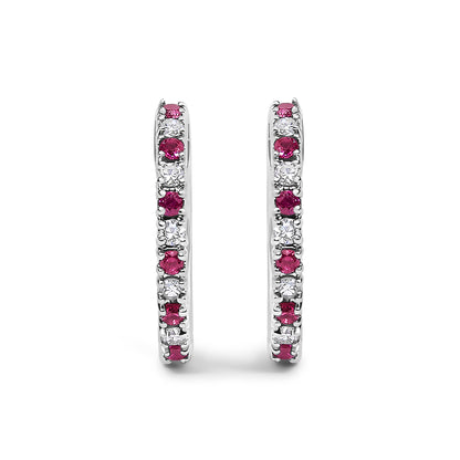 Pair of white metal hoop earrings with alternating red and white round gemstones in prong settings, shown in front view on a white background.