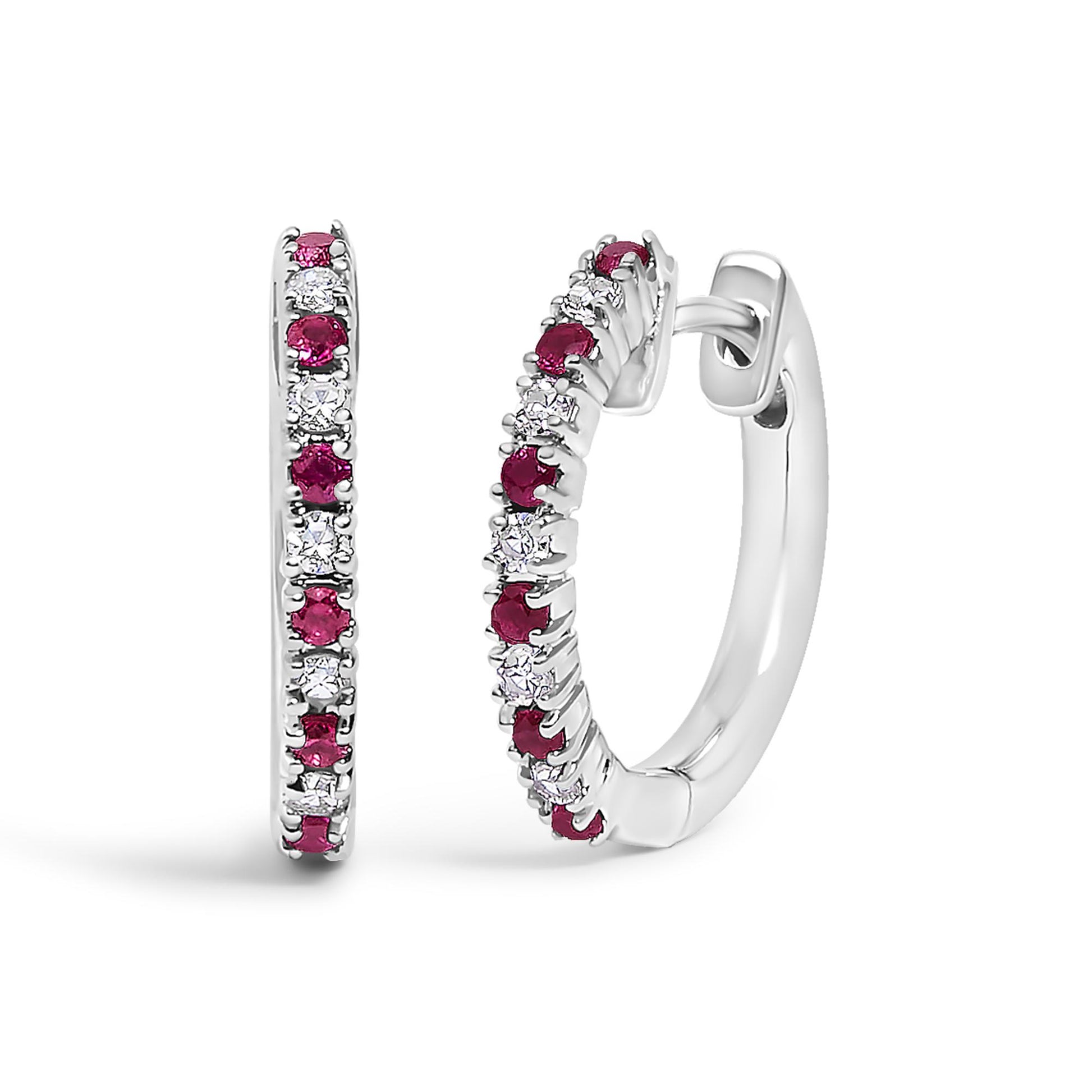 Close-up front and side view of a pair of white hoop earrings set with alternating round white and red gemstones in prong settings.
