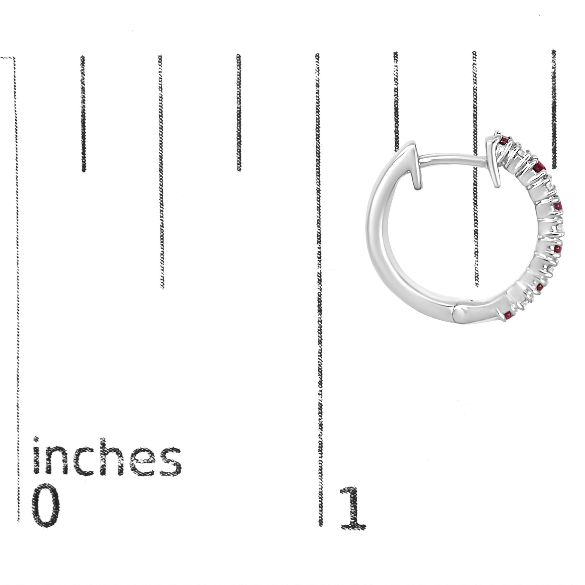 White metal hoop earring with alternating white and red round gemstones set in prongs, shown on a scale with inch markings, side angle.