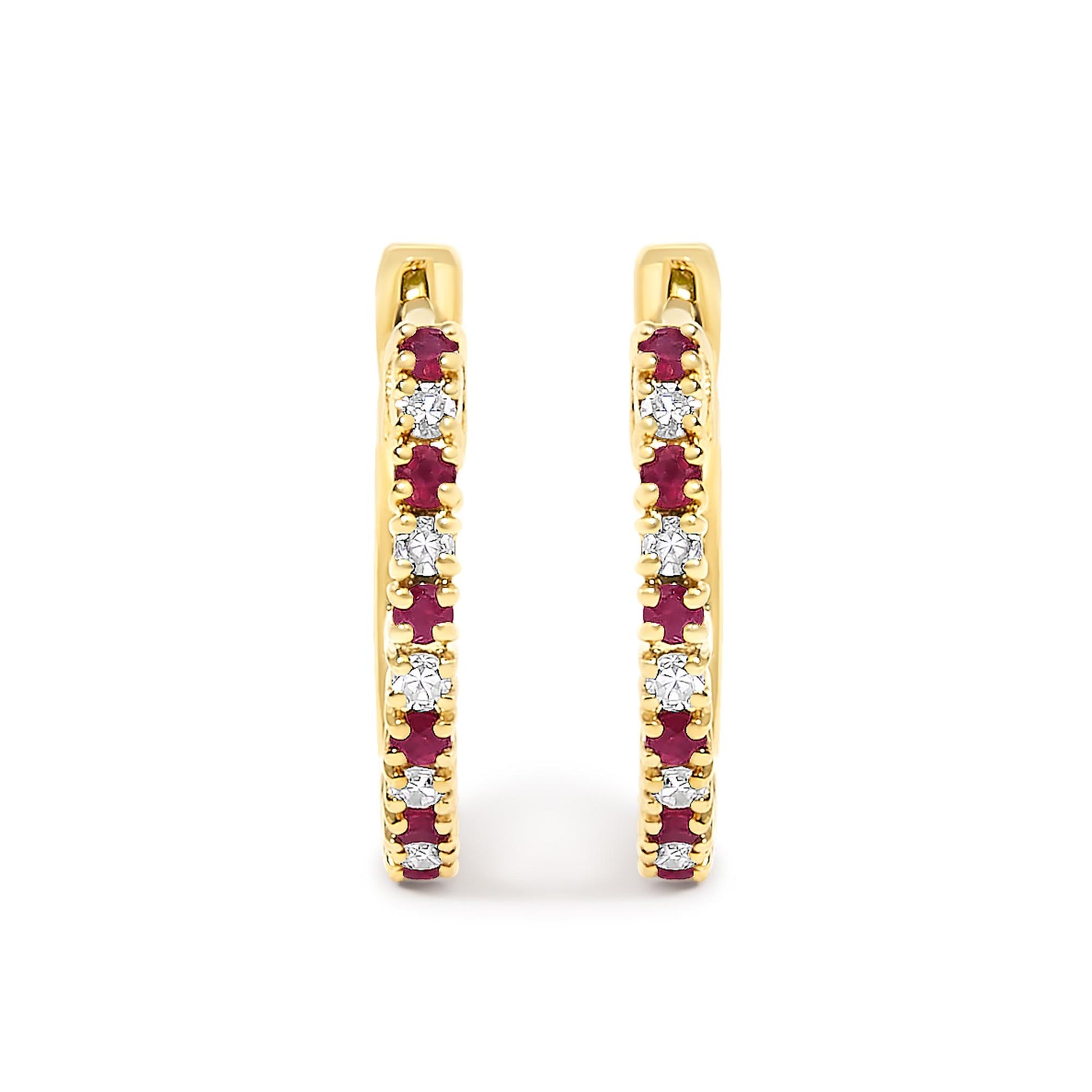 Front-facing close-up of yellow metal hoop earrings adorned with alternating round white and red gemstones in prong settings.
